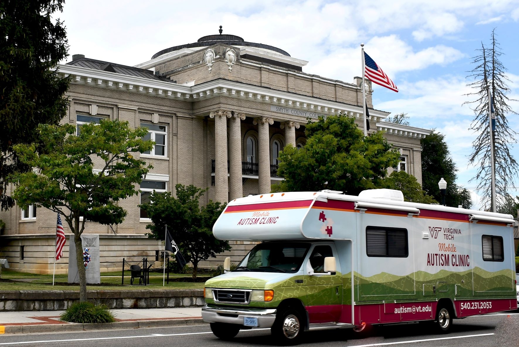 The Mobile Autism Clinic RV driving in front of the courthouse in downtown Marion, Virginia.